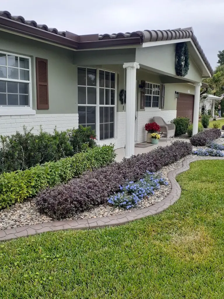 Grey border along front beds with hedges and purple plants